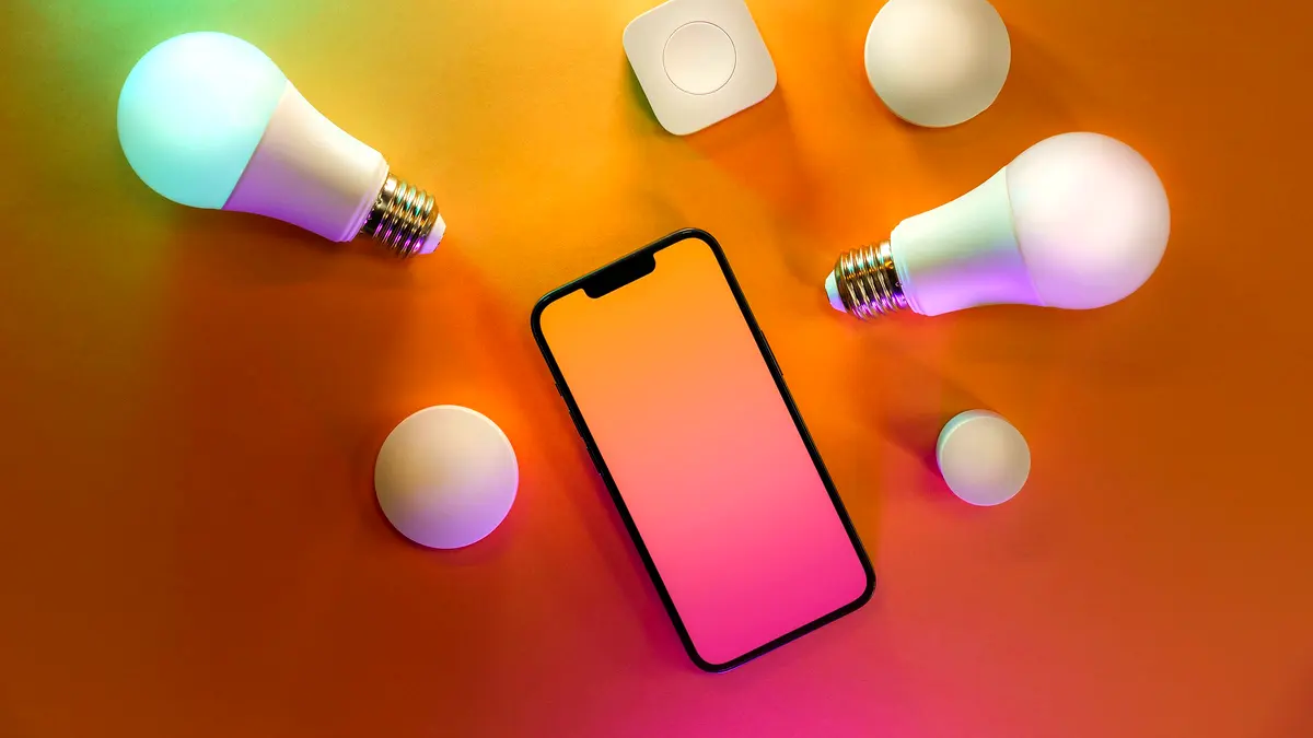 Smart bulbs arranged around a phone with a blank screen.