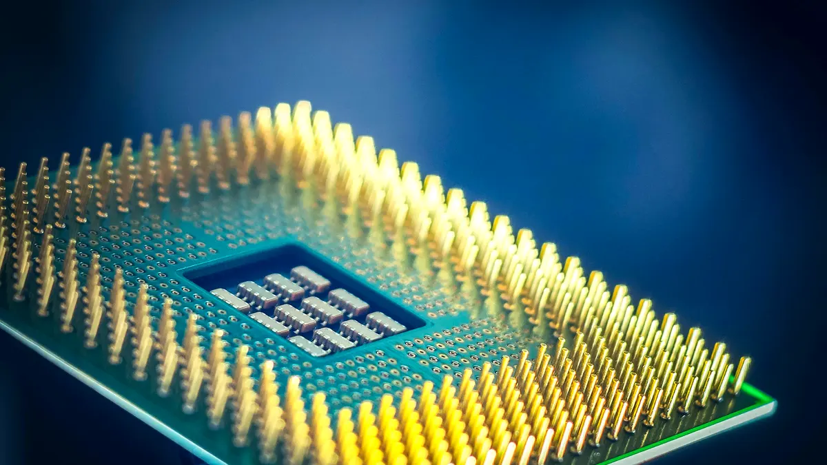 Macro photograph of a processor's gold pins against a blue background.