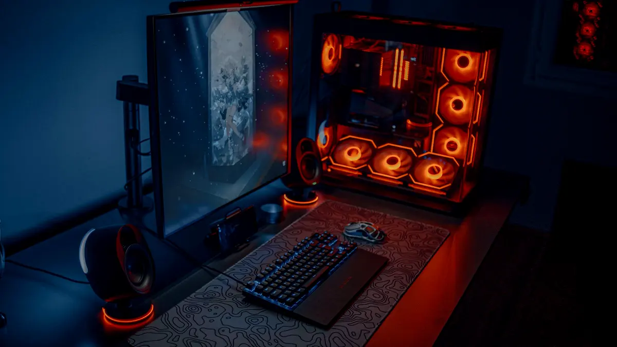 A desktop gaming setup with a wide monitor and RGB lighting.