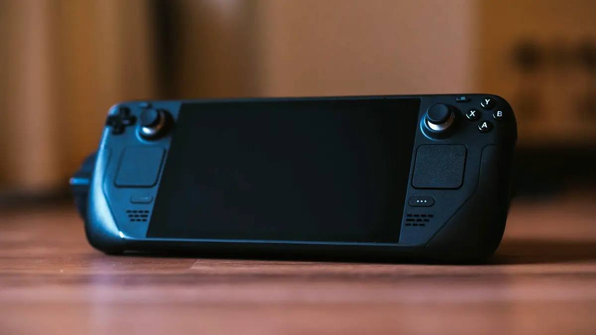 A modern handheld gaming console on a wooden surface.