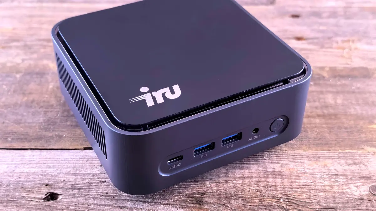 The rear port cluster of a compact desktop computer, showing USB-C and several USB-A ports.