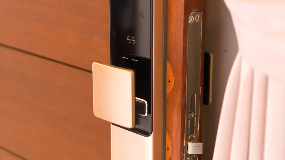 A smart lock fitted to a wooden front door.