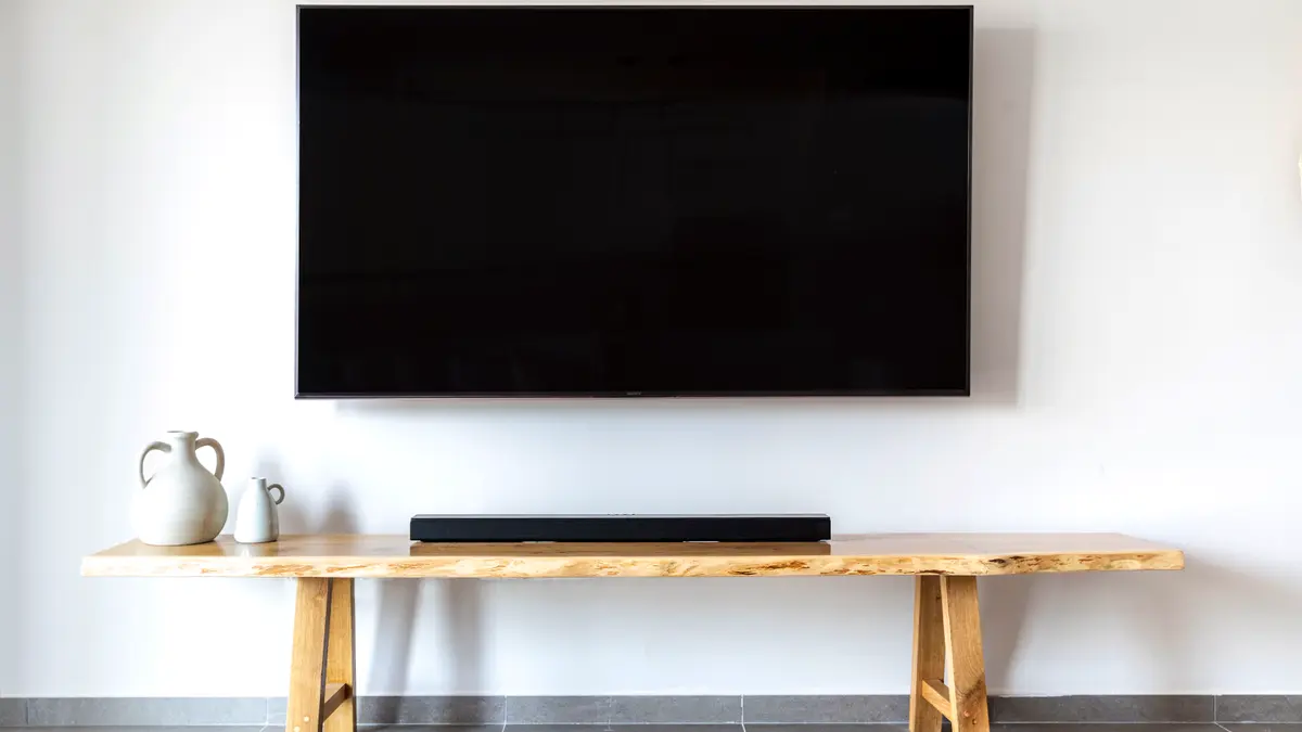 A wall-mounted flat-screen television in a minimalist living room.