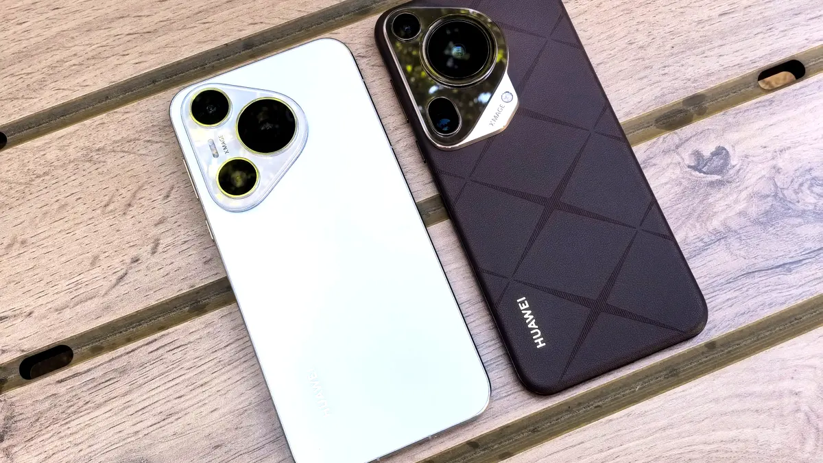 Two smartphones side by side on a wooden table.