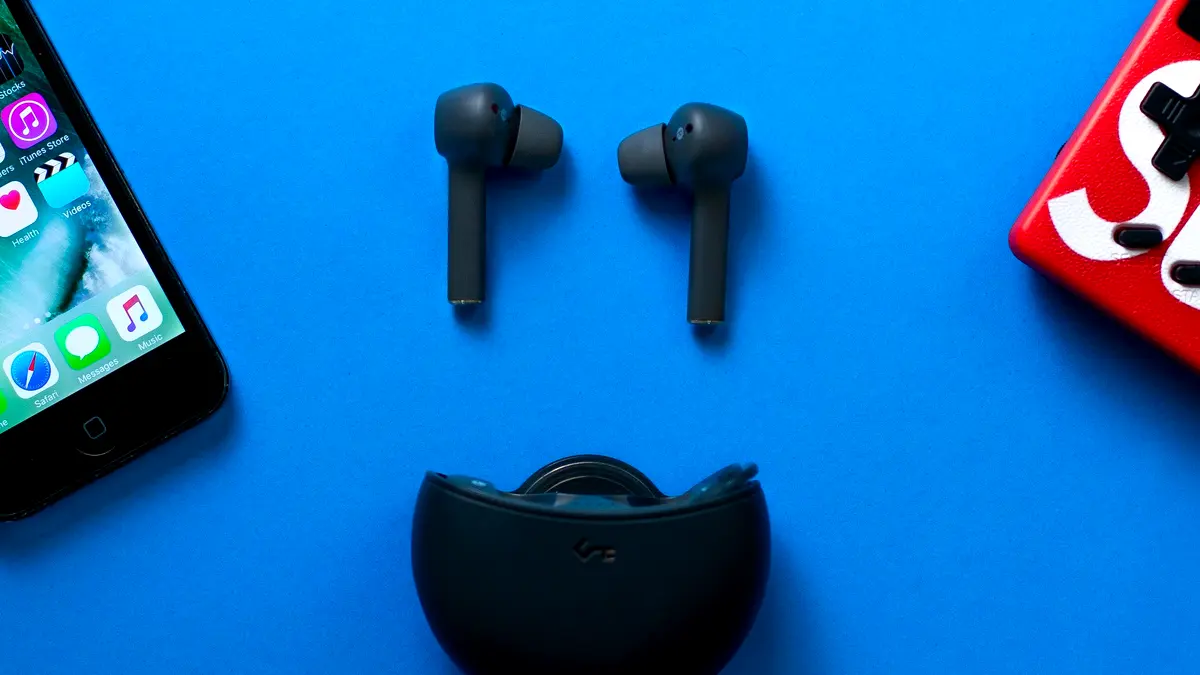 Wireless earbuds and their charging case on a blue background.